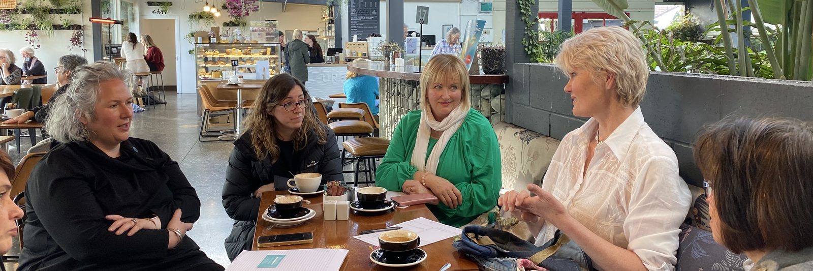 Women in conversation over coffee at an Empowerment Project networking meetup in Canterbury
